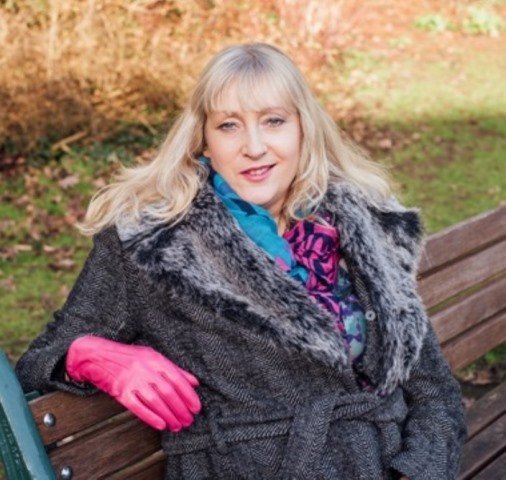 Me looking relaxed sitting on a bench in the winter sun.